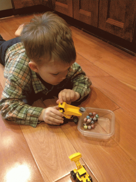 Tucker transferring magnets and beads from digger to dump truck to food storage.